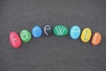 Farewell word composed with multicolored stones over black volcanic sand Royalty Free Stock Photo