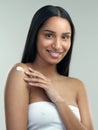 If you want soft skin, you gotta moisturise. a beautiful young woman applying moisturiser to her skin.