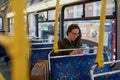 If youre gonna text, take the bus. High angle shot of an attractive young woman listening to music while sitting on a Royalty Free Stock Photo