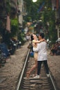 If youre not madly in love whats the point. a young couple dancing on the train tracks in the streets of Vietnam.