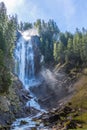 Iffigfall waterfall near Lenk, blue sky, forest