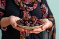 Iftar delight Modern Muslim woman holds plate of sweet dates