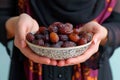 Iftar delight Modern Muslim woman holds plate of sweet dates