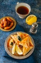 Iftar food during ramadan, arabic and middle eastern food concept. Fatayer sabanekh - traditional arabic spinach triangle hand pi Royalty Free Stock Photo