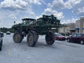 IGA grocery store parking lot large green farm machinery