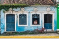 Man looking out a window from a colonial style house in the historic center of Igarassu