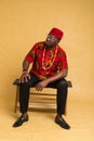 Igbo Traditionally Dressed Business Man Sitting Down and Posturing Royalty Free Stock Photo