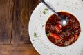 Ãâigh angle shot of cuttlefish with tomato sauce, white plate on rustic background Royalty Free Stock Photo