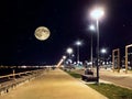 Ight promenade starry sky full moon people walk street lantern light urban city Tallinn old town sea port Baltic Estonia Royalty Free Stock Photo