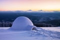 Igloo the house of isolated tourist is standing on high mountain far away from the human eye. Amazing winter sunrise. Marvelous