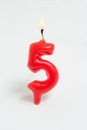 Ignited candle number five Royalty Free Stock Photo