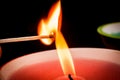 Igniting matches from a candle fire. Sulfur ignition close up. Macro shooting Royalty Free Stock Photo