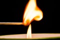 Igniting matches from a candle fire. Sulfur ignition close up. Macro shooting Royalty Free Stock Photo