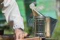 Ignition of a bee-keeper`s smoker for fumigation of beehives on an apiary