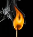 Ignition of a match, with smoke on dark background Royalty Free Stock Photo