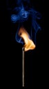 Ignition of a match, with smoke on dark background