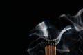 Ignition of matches with smoke, isolated on black background. Match just after burning Royalty Free Stock Photo