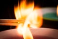 Ignition of two matches from the fire of a candle. Sulfur ignition close up. Macro shooting Royalty Free Stock Photo