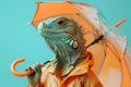 Iguana in orange raincoat with matching umbrella. Concept of seasonal protection.