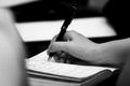 Close up of a businesswoman taking notes at a business conference or seminar. Royalty Free Stock Photo