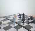 Iillustration for photo War, battle or politic situation concept, 2 standing mini figure, negoitation or debate beyond chess