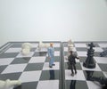 Iillustration for photo War, battle or politic situation concept, 2 standing mini figure, negoitation or debate beyond chess