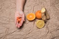 Fruits and tablets, vitamins on a background of crumpled paper.