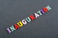 Iinauguration . English word on black board background composed from colorful abc alphabet block wooden letters, copy