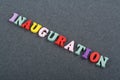 Iinauguration . English word on black board background composed from colorful abc alphabet block wooden letters, copy