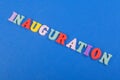 Iinauguration . English word on blue background composed from colorful abc alphabet block wooden letters, copy space for