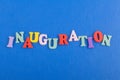 Iinauguration . English word on blue background composed from colorful abc alphabet block wooden letters, copy space for