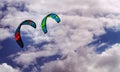 Two board kites against a cloudy sky