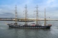 Ijmuiden, Netherland - August 18 2015: Tall ship passing lighthouse in the rain storm Royalty Free Stock Photo