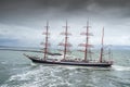 Ijmuiden, Netherland - August 18 2015: Tall ship passing lighthouse in the rain storm Royalty Free Stock Photo