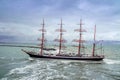 Ijmuiden, Netherland - August 18 2015: Tall ship passing lighthouse in the rain storm Royalty Free Stock Photo