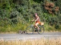 Dutch woman riding a bicycle walking dog