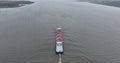 Ijselmeer, 3th of December 2022, The Netherlands. Inland shipping vessel on open water of Ijselmeer. Aerial drone follow