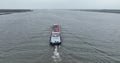 Ijselmeer, 3th of December 2022, The Netherlands. Inland shipping vessel on open water of Ijselmeer. Aerial drone follow