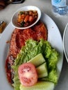 Ikan fish bakar with sauce & vegetable authentic yummy spicy food from Indonesia with soysauce Royalty Free Stock Photo