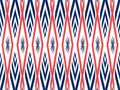 Ikat pattern as ethnic fabric in colorful. Wallpaper seamless pattern design in white, navy blue and orange color. Royalty Free Stock Photo