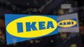 Ikea logo on the glass against blurred business center. Editorial 3D rendering