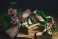 Ikebana. A bouquet of Asclepias syriaca flowers in a pile of wooden bars. still life of flowers and wood