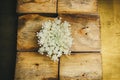 Ikebana. A bouquet of white wildflowers in a pile of wooden bars. still life of flowers and wood. close-up. top view