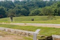 Person mowing lawn at archaeological site Royalty Free Stock Photo