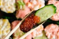 Ikura gunkan with cucumber and orange salmon roe.