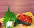 Ikura sushi on wooden plate - selective focus. Royalty Free Stock Photo