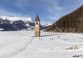 The submerged bell tower of Resia with snow