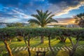 Il-Mellieha, Malta - Beautiful sunset scene at Mellieha town with palm trees, bench