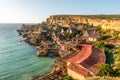 Il-Mellieha, Malta - Panoramic skyline view of the famous Popeye Village at Anchor Bay at sunset Royalty Free Stock Photo