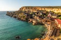 Il-Mellieha, Malta - Panoramic skyline view of the famous Popeye Village at Anchor Bay at sunset Royalty Free Stock Photo